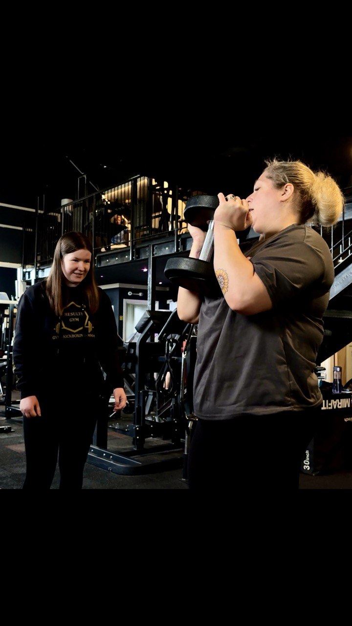 A Results Gym trainer coaching a client during a one-to-one gym session