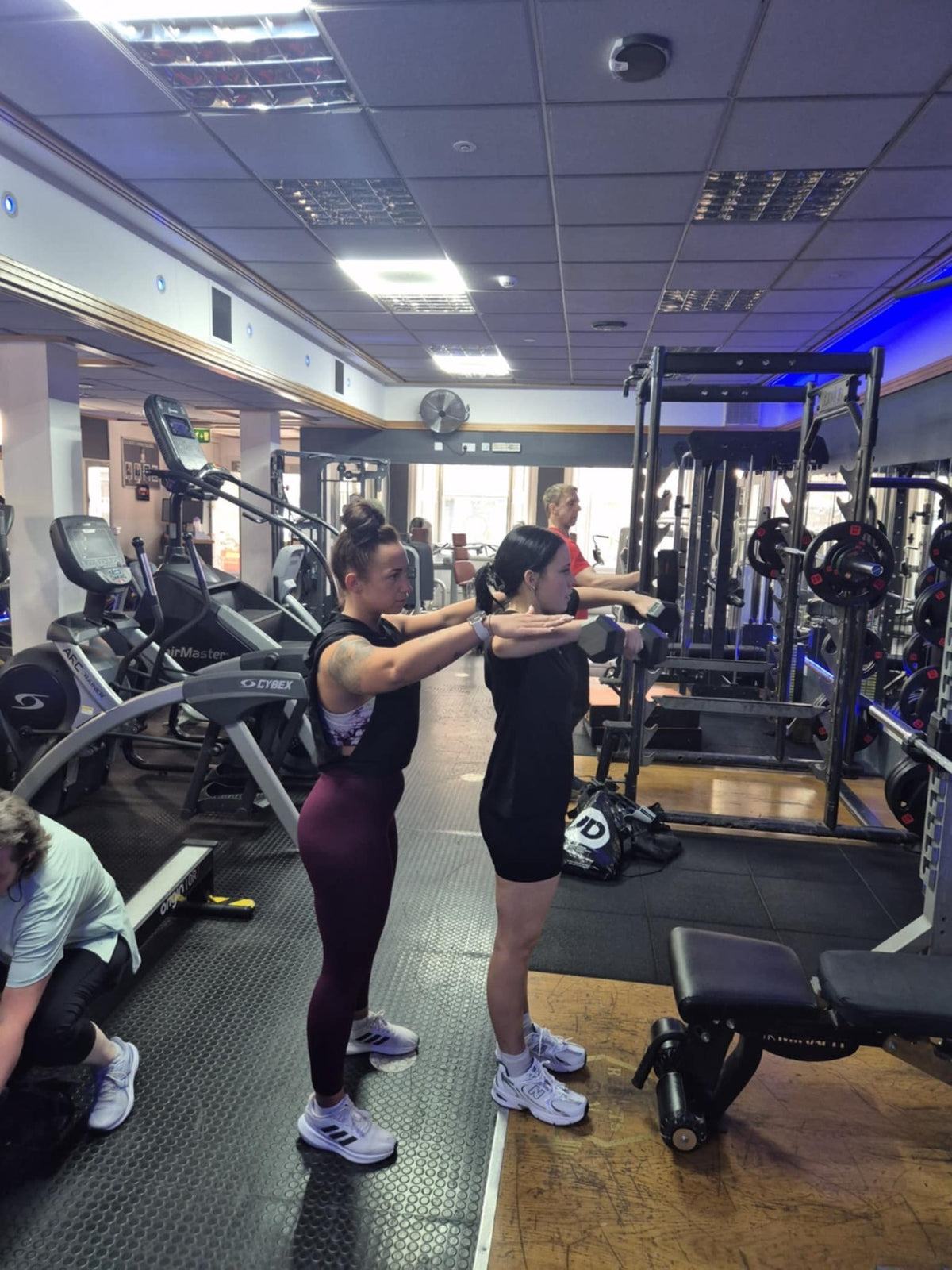 Two members exercising together on the Results Gym training floor